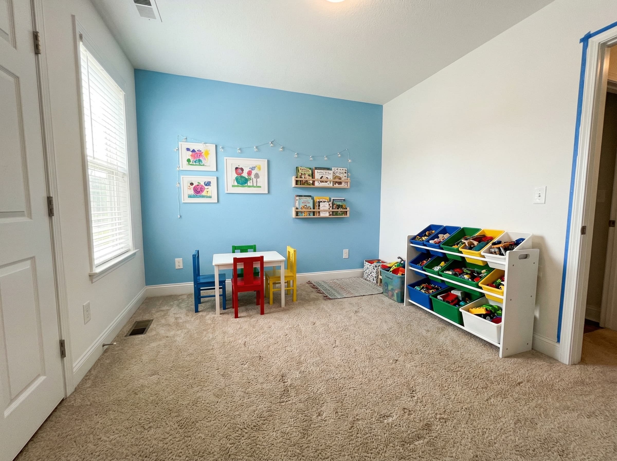Kids playroom accent wall — cheerful blue with white walls, Sacramento family home